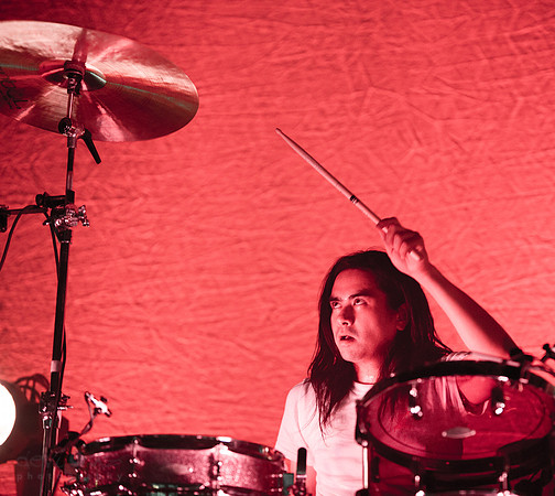 Christopher Guanlao, reaching for his signature high cymbal