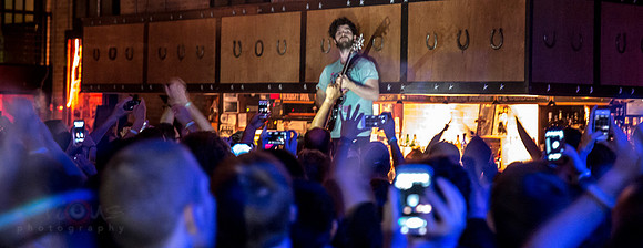 Yannis Philippakis, standing on the bar at High-Noon