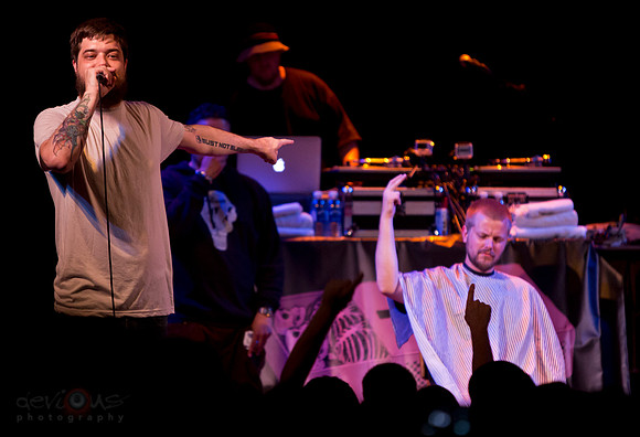 Aesop Rock rapping while dude gets terrible haircut on stage