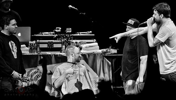 Aesop Rock rapping while dude gets terrible haircut on stage